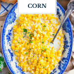 Bowl of crock pot creamed corn with text title overlay