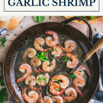 Pan of garlic shrimp with text title box at top