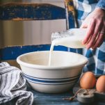 Pouring buttermilk into a large bowl