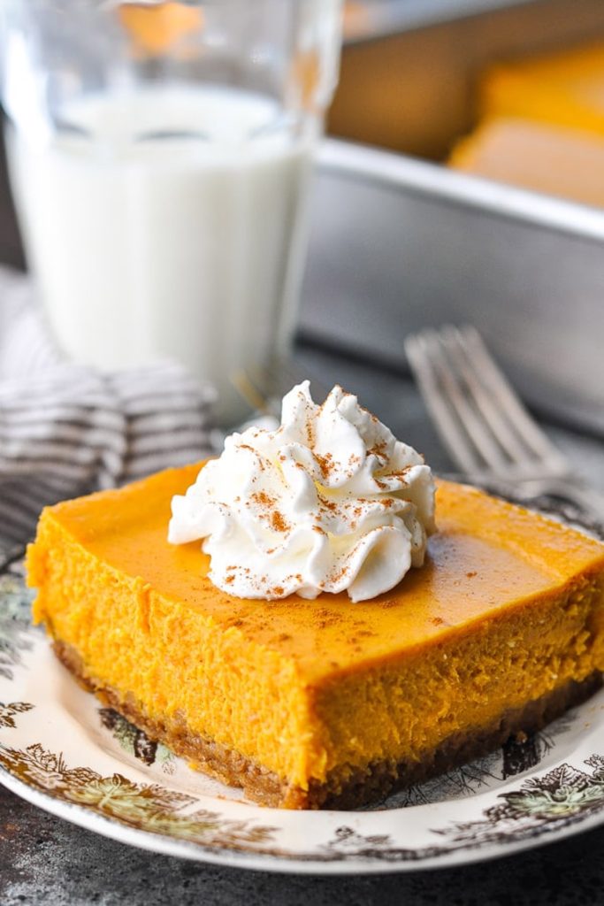 Front shot of a plate of pumpkin cheesecake bars