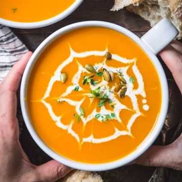 Square overhead shot of a bowl of roasted butternut squash soup