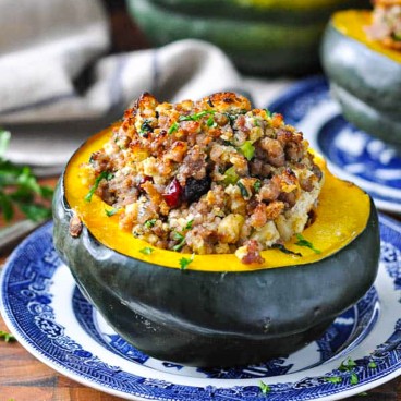Square side shot of stuffed acorn squash with sausage and apples