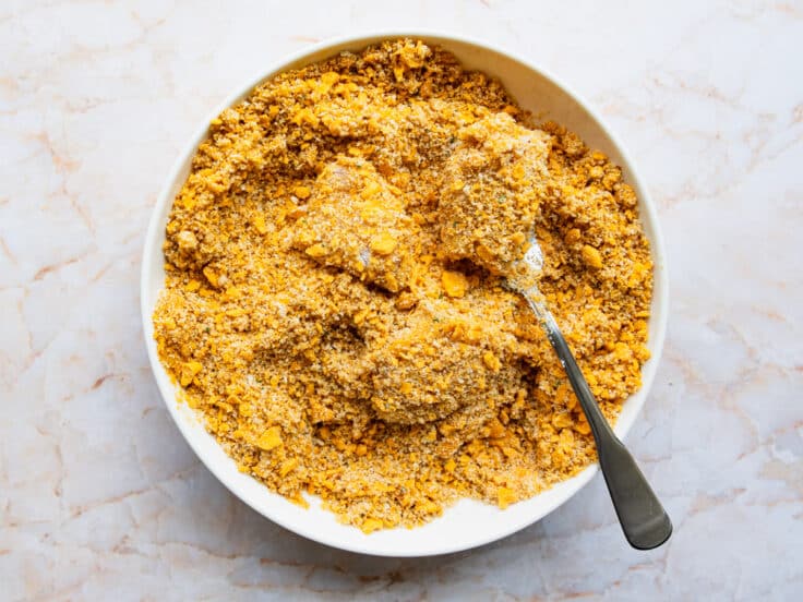 Dredging the chicken in the Goldfish crumb coating.