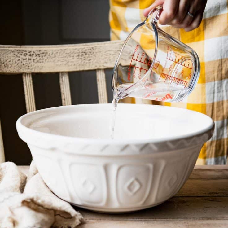 Pouring 7 up into a white mixing bowl.