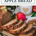 Sliced loaf of apple bread with text title box at top