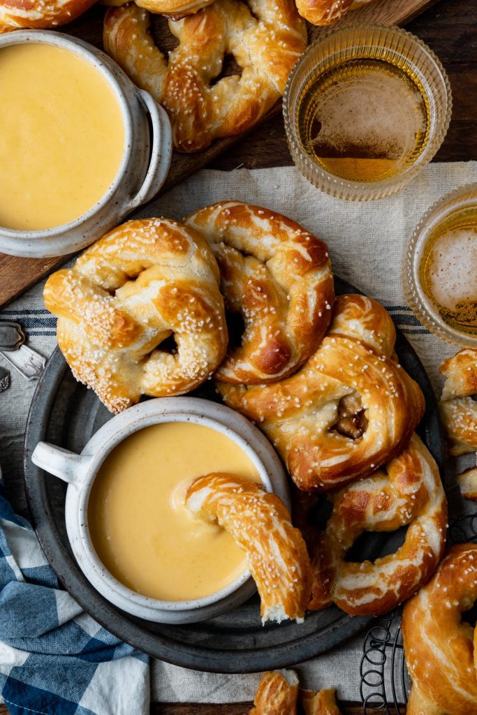 Overhead image of a platter of beer cheese dip with pretzels
