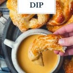 Overhead image of hand dipping pretzel in beer cheese dip with text title overlay