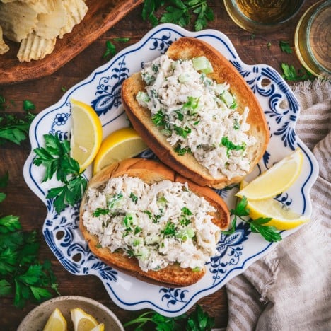 Square overhead image of crab roll recipe on a blue and white tray