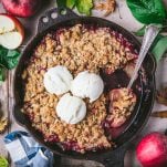 Square overhead shot of an apple cranberry crisp in a cast iron skillet