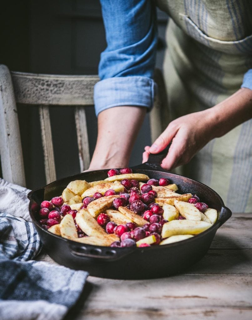 Apples and cranberries in a cast iron skillet