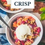 Bowl of apple cranberry crisp with text title overlay