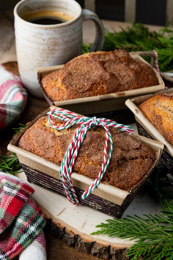 Three small loaves of date nut bread on a holiday table