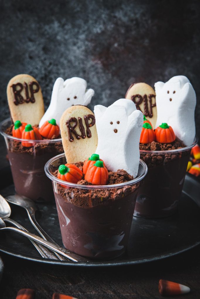Front shot of easy halloween dessert recipes with dirt pudding cups on a platter