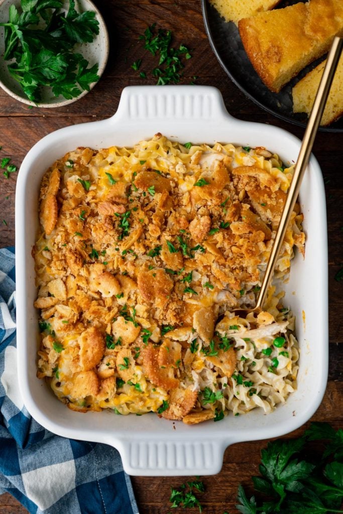 Overhead shot of turkey casserole with egg noodles in a white dish on a wooden table