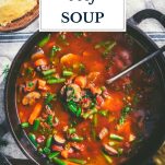 Pot of vegetable beef soup with text title overlay