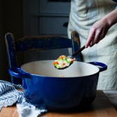 Sauteing vegetables in a blue Dutch oven