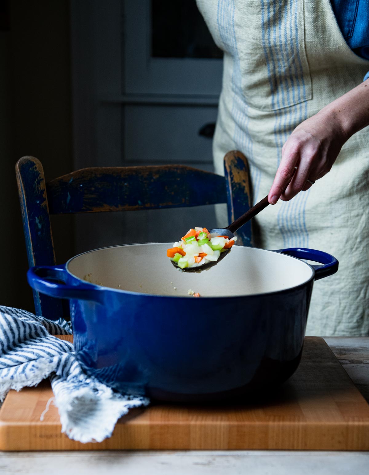 Sauteing vegetables in a blue Dutch oven