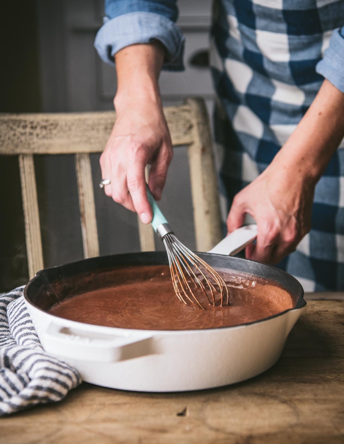 Whisking chocolate gravy in a cast iron skillet