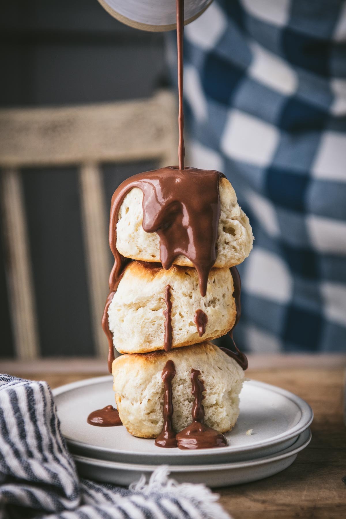 Pouring southern chocolate gravy over three buttermilk biscuits