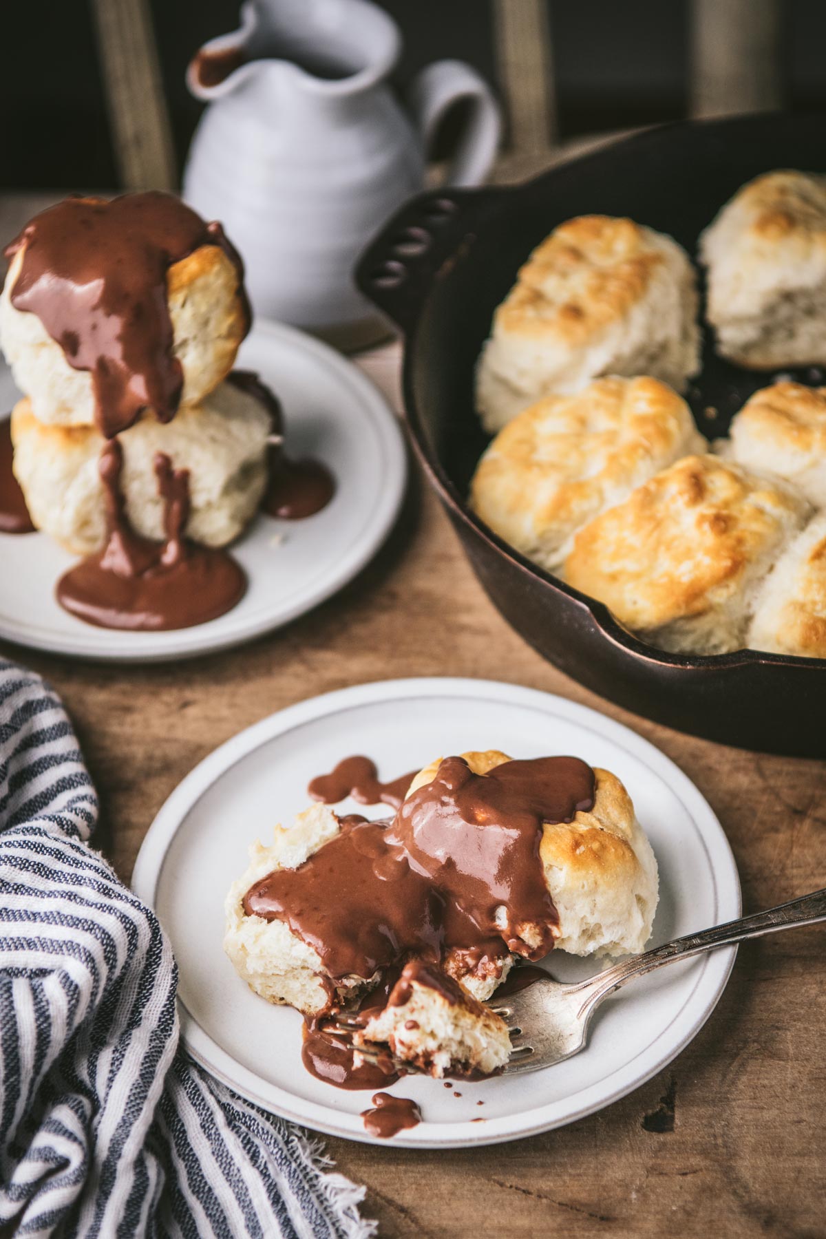 Front shot of a table of biscuits and chocolate gravy