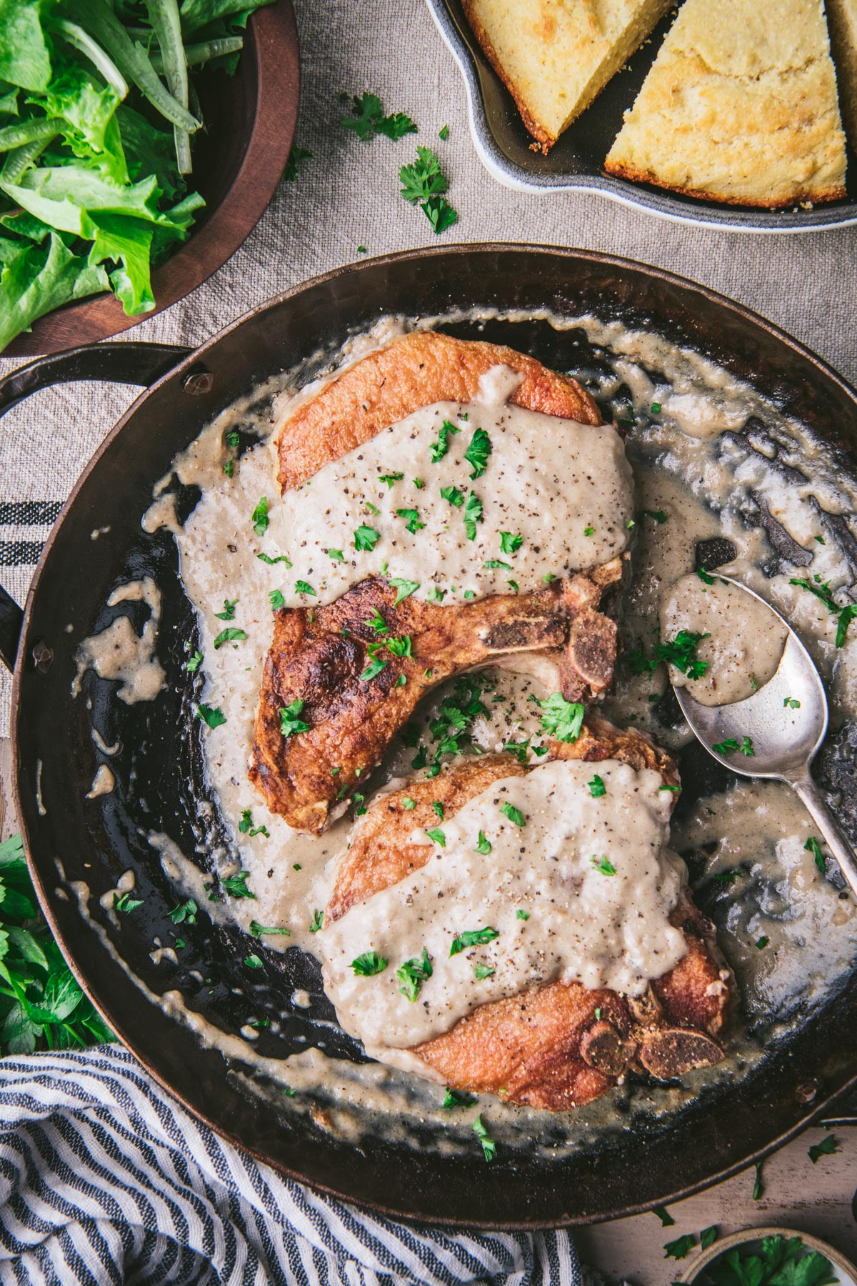 Close overhead image of two large pork chops with gravy