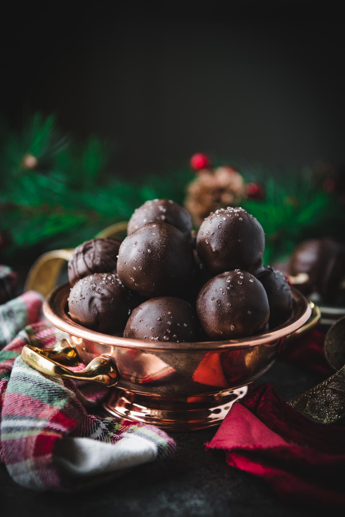Dark chocolate peanut butter balls in a copper ball