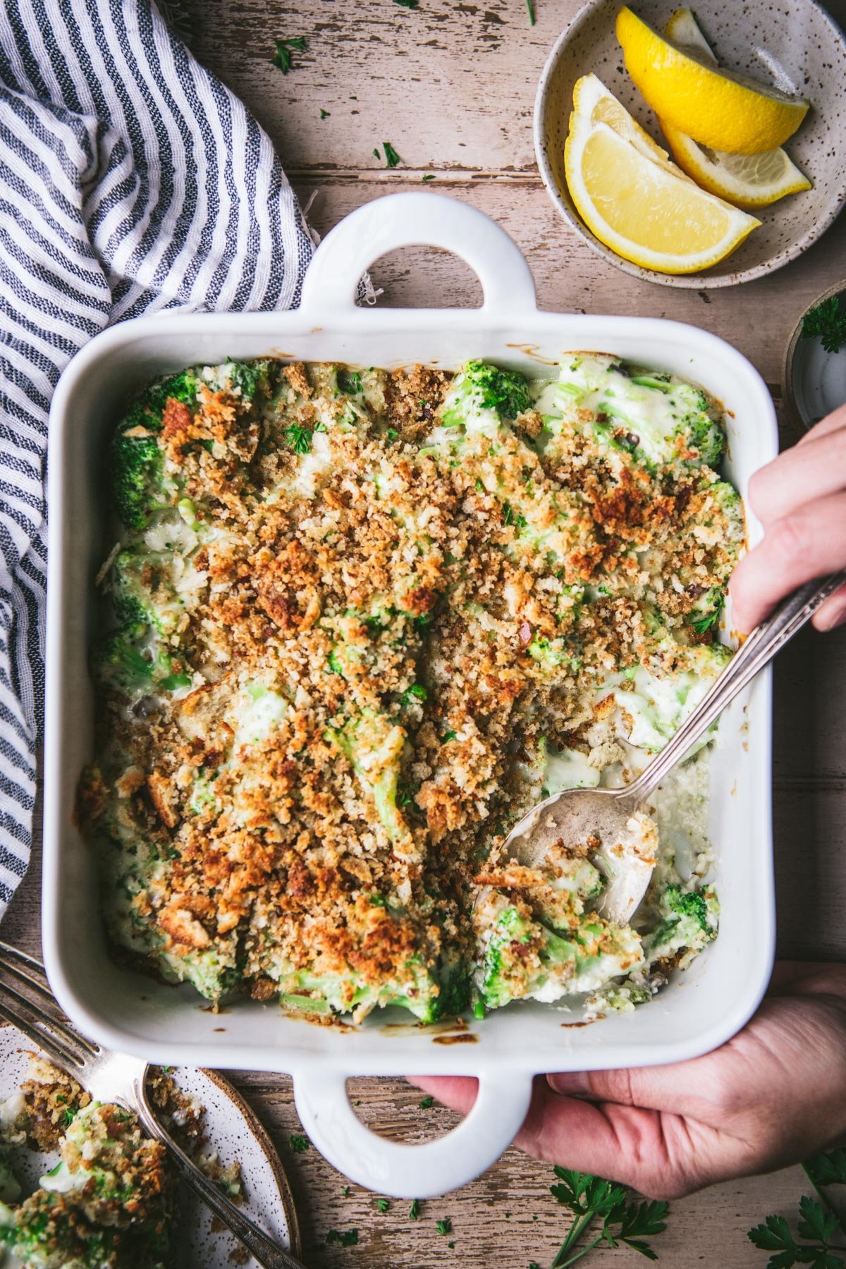 Overhead image of a square white dish full of broccoli casserole