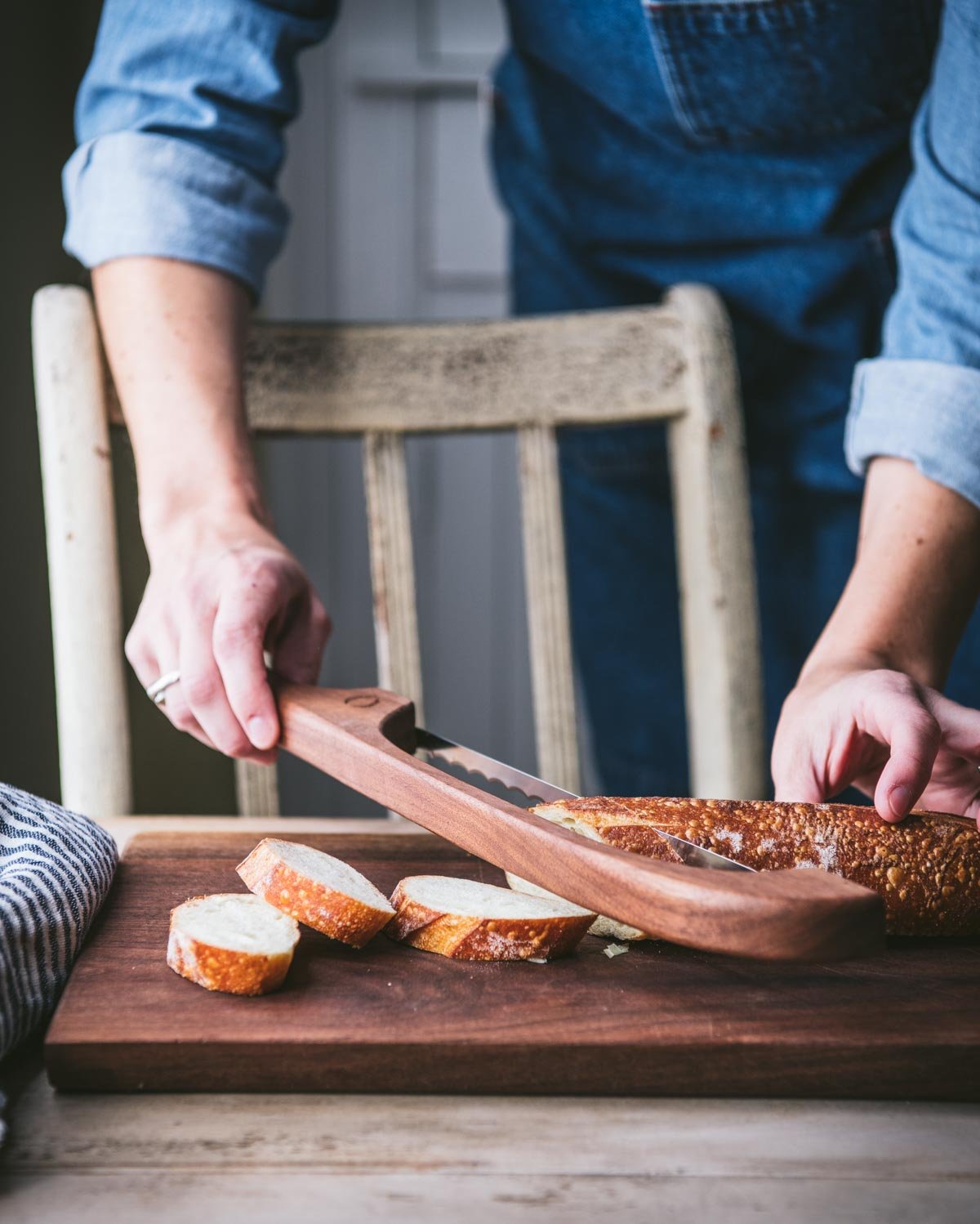 Slicing baguette on a bread board