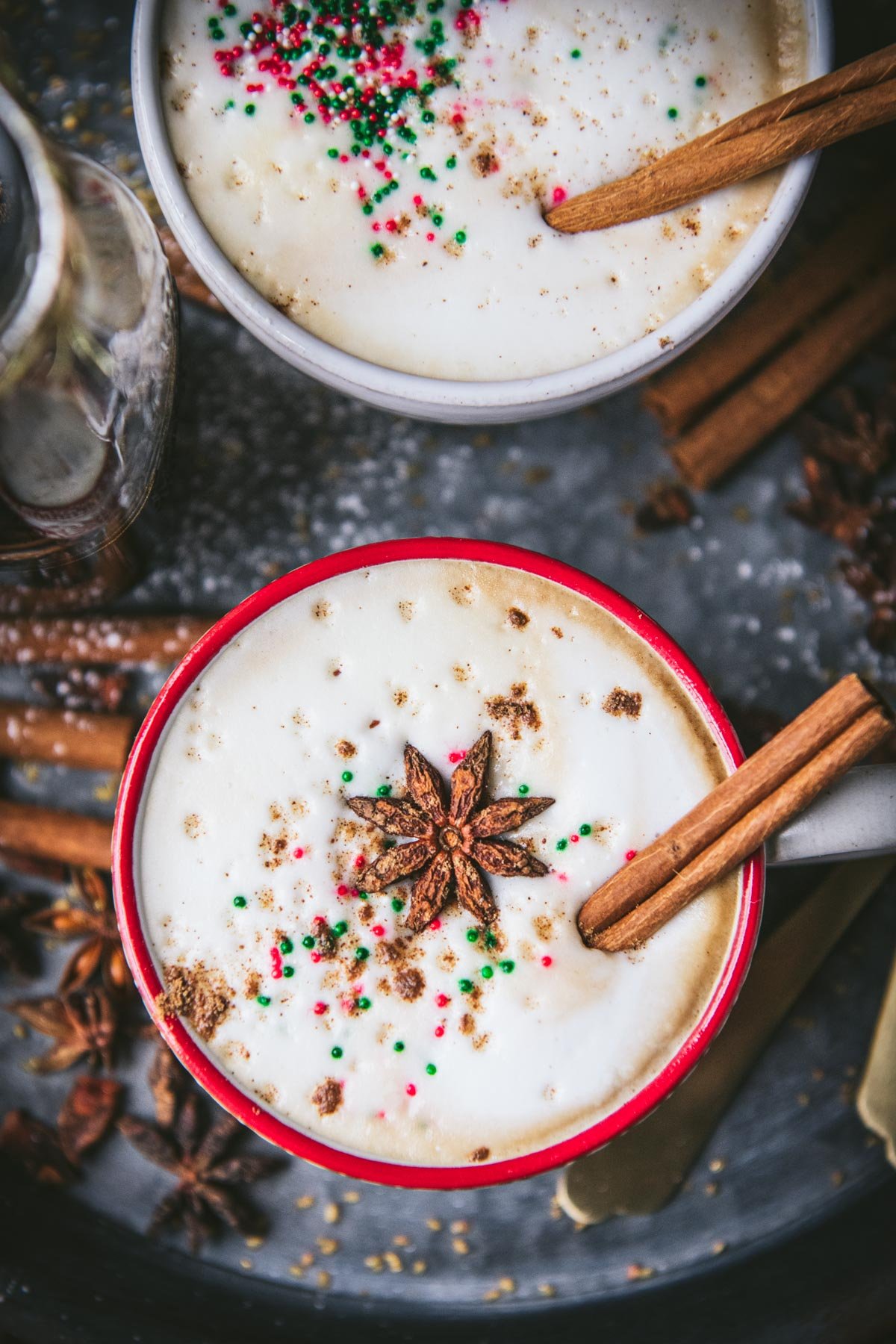 Overhead shot of a gingerbread latte in a holiday mug with a cinnamon stick