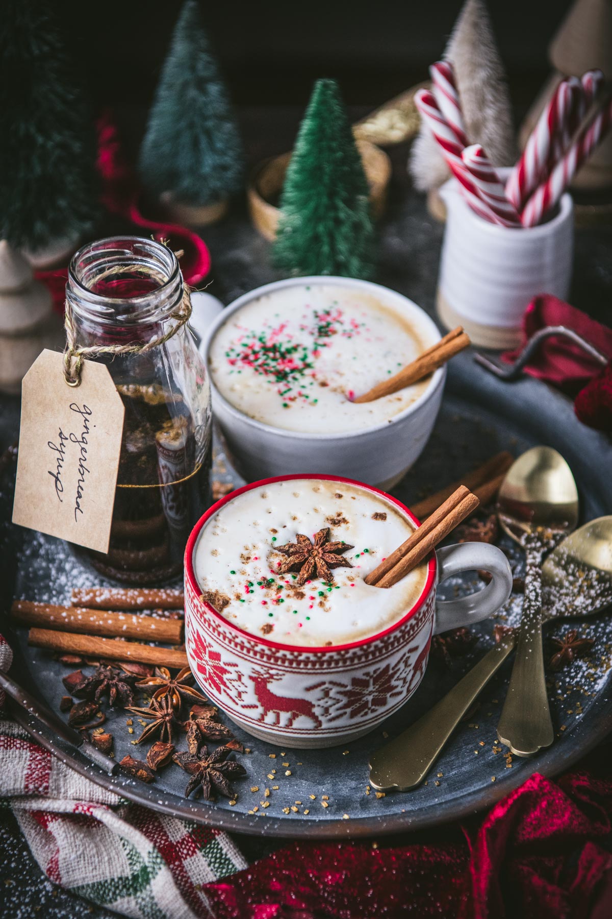 Try of homemade gingerbread lattes on a table with holiday decorations