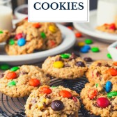 Monster cookies on a cooling rack with text title overlay