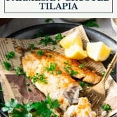Side shot of a plate of baked tilapia with text title box at top