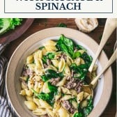 Bowl of pasta with sausage and spinach with text title box at top