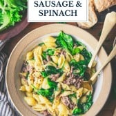 Bowl of pasta with sausage and spinach with text title overlay