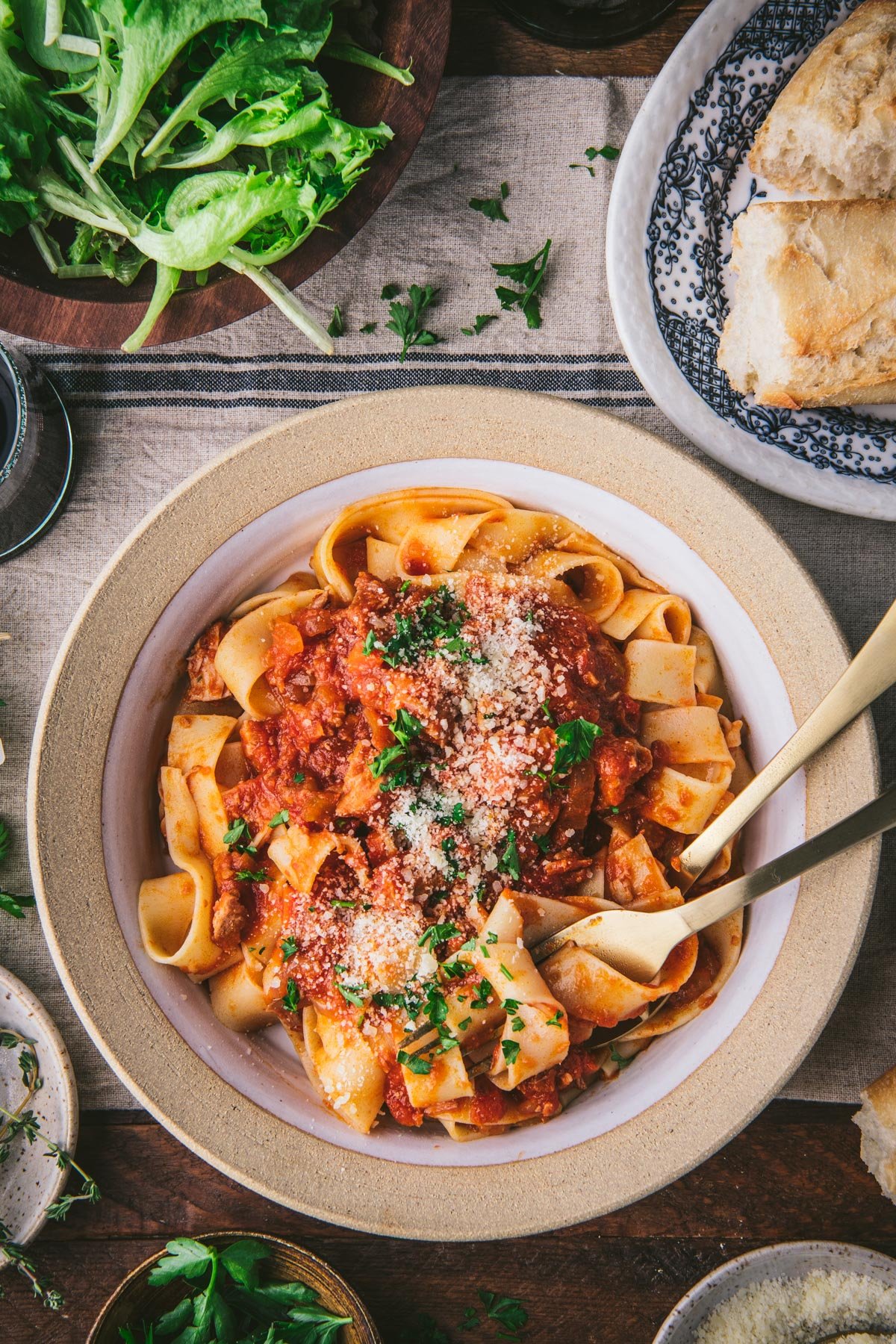 Overhead image of pappardelle pasta with pork ragu on a dinner table