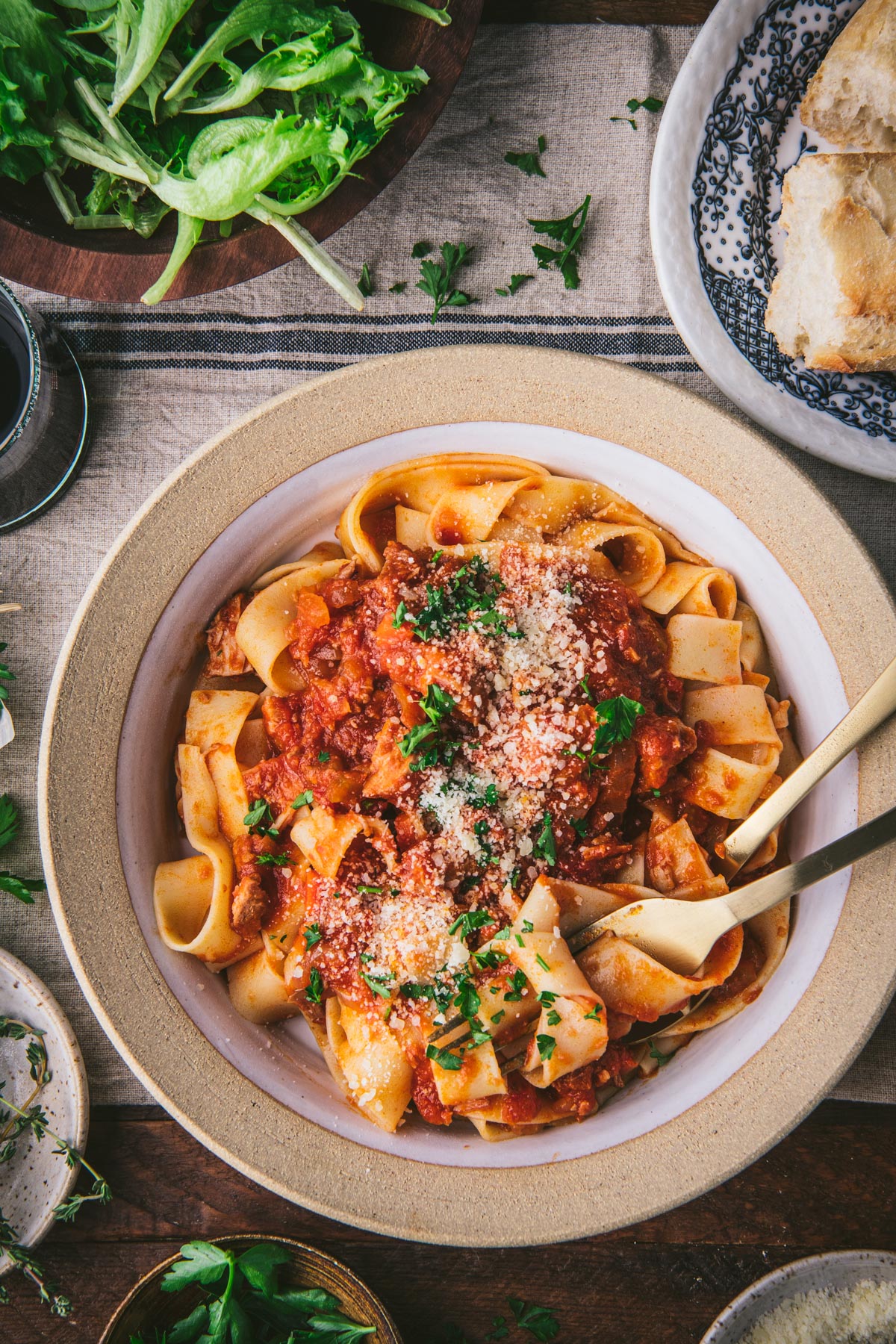 Close overhead image of a bowl of pork ragu with pappardelle pasta