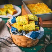 Square side shot of a basket of Jiffy cornbread with broccoli on a table