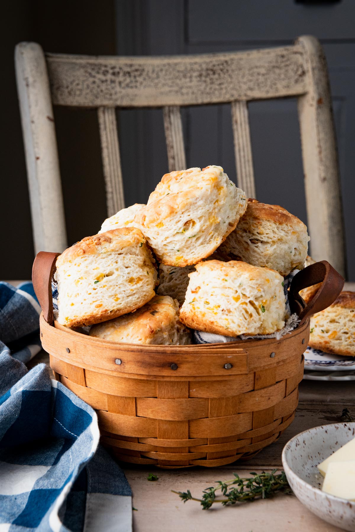 Cheddar biscuits with chives and bacon in a basket on a breakfast table