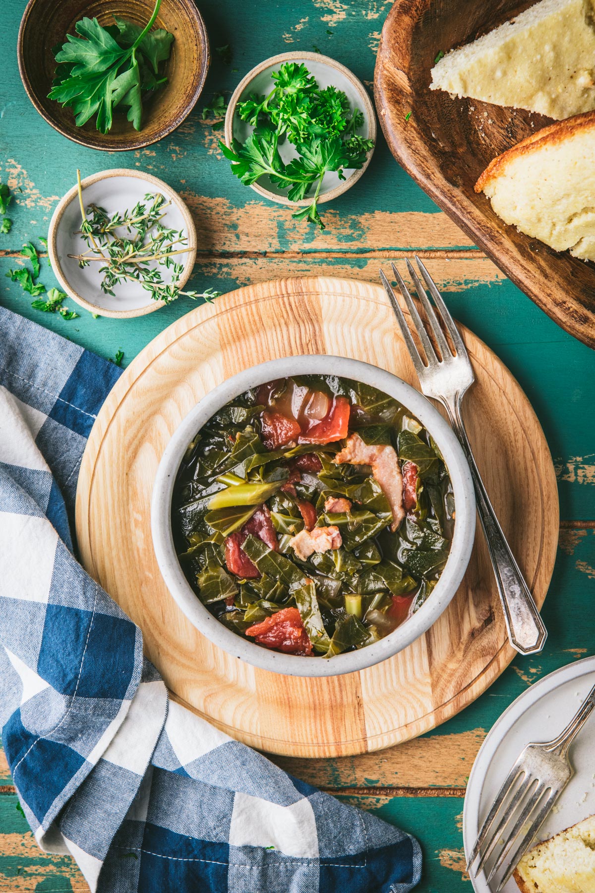 Southern collard greens with tomatoes and bacon on a turquoise dinner table