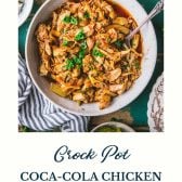 Bowl of crock pot coca cola chicken with text title at the bottom
