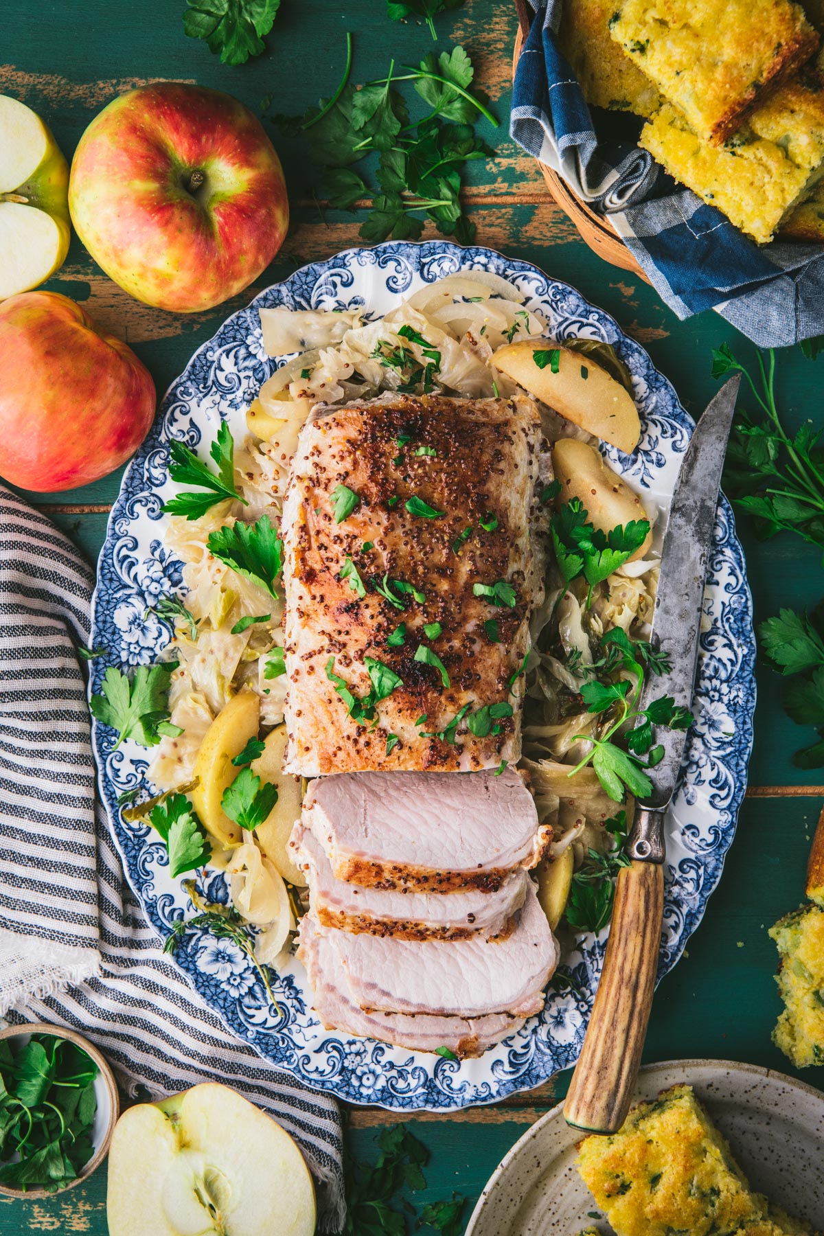 Tray of slow cooker pork loin with apples and cabbage on a platter