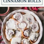 White dish of traditional cinnamon rolls with text title box at top