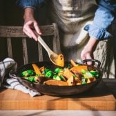 Cooking sweet potatoes and Brussels sprouts in a cast iron skillet