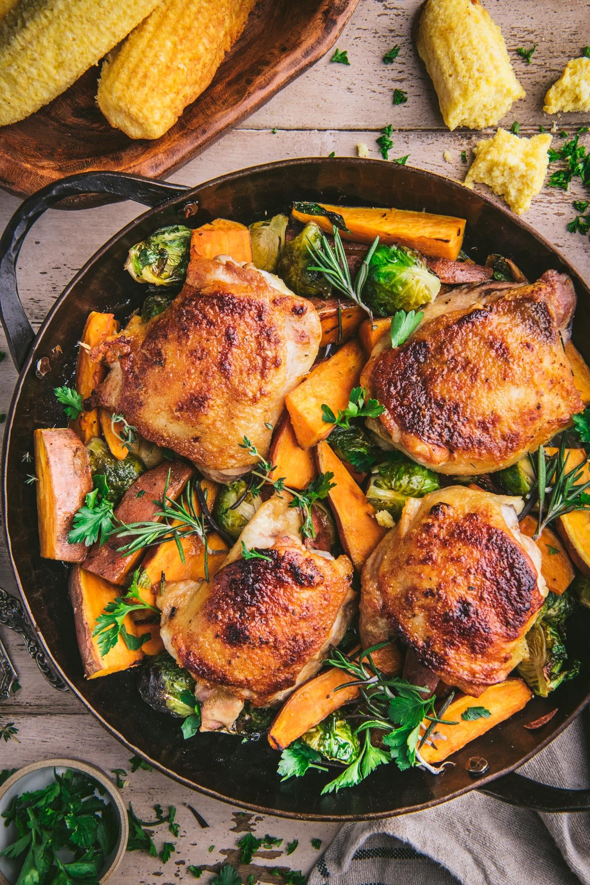 Close overhead image of maple roasted chicken thighs in a cast iron skillet