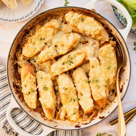 Square overhead image of a pan of French onion chicken casserole.