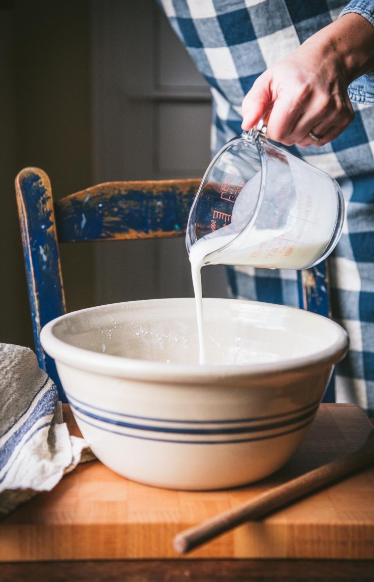 Pouring buttermilk into a bowl.