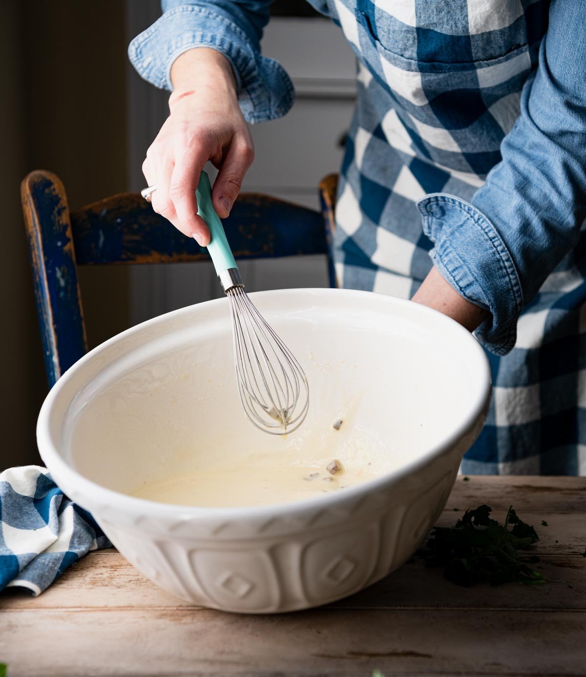 Whisking condensed soups in a white bowl