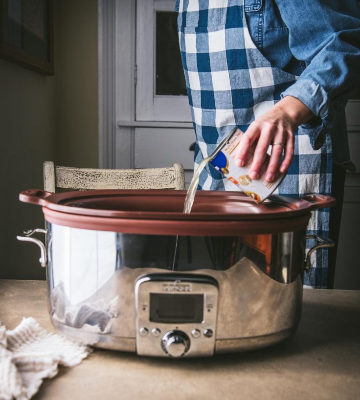 Process shot showing how to make crock pot chicken and noodles.