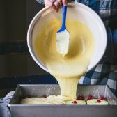 Pouring cake mix batter into a pan.