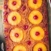 Pineapple upside down cake on a table before slicing